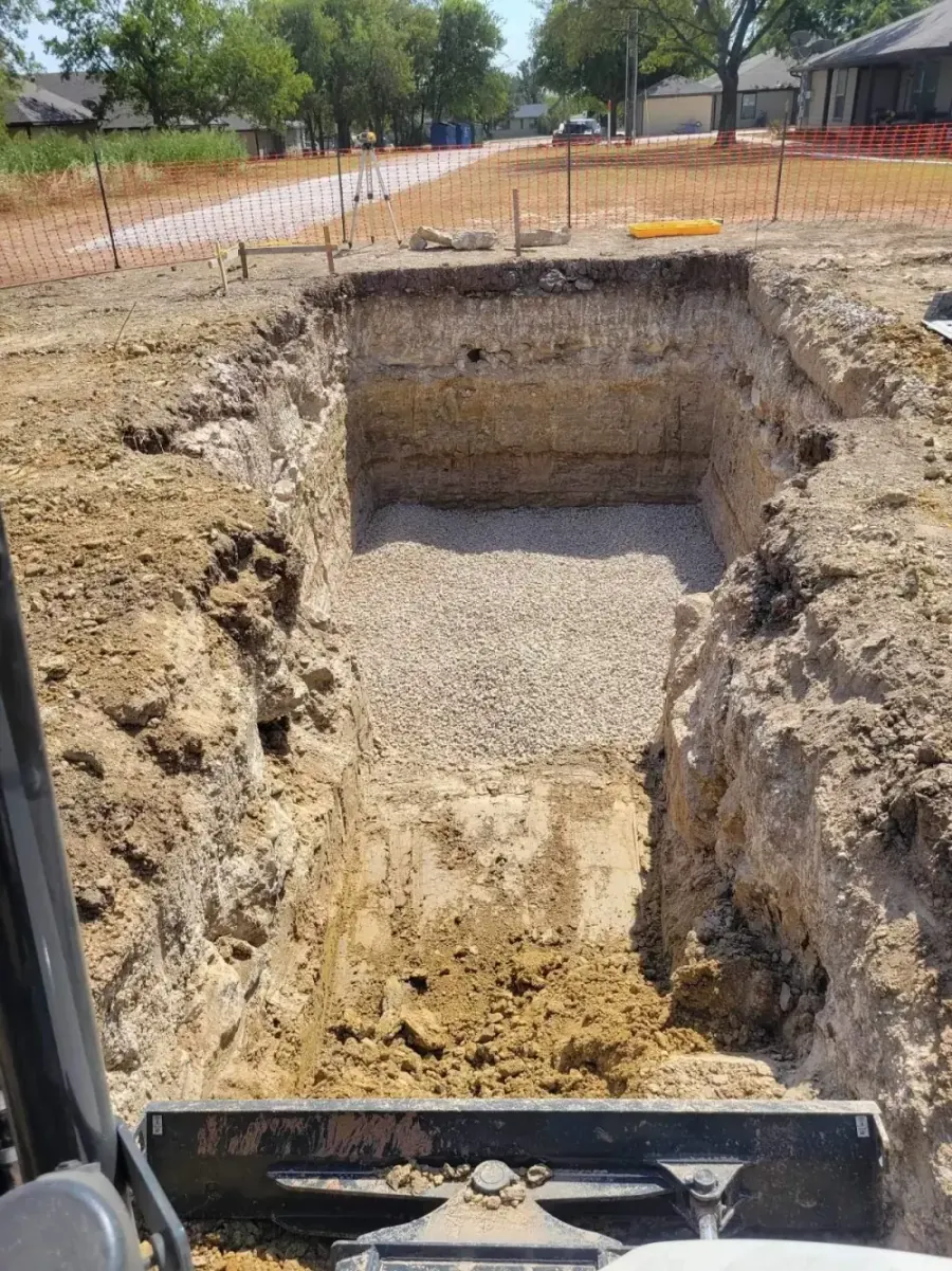 Rectangular excavated pit with clean gravel base ready for a pool pad or pond structure in Celina TX